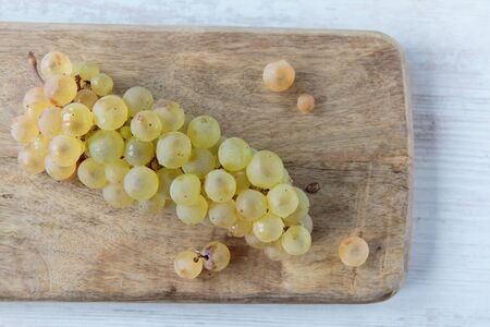 Fresh white whine grapes on a chopping boardの写真素材