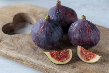 Delicious fresh dark figs on a chopping board