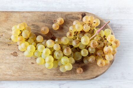 Fresh white whine grapes on a chopping boardの写真素材