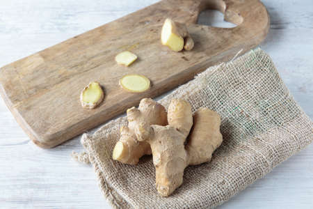 Fresh healthy ginger root on jute clothの写真素材