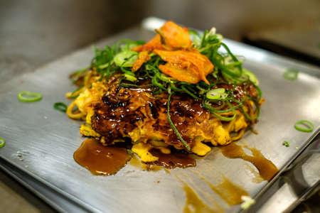 Typical tasty japanese okonomiyaki fast food in Kyotoの写真素材