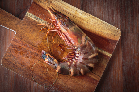 Delicious fresh prawn on wooden chopping boardの写真素材