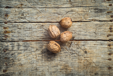 Fresh raw walnuts on a wooden backgroundの写真素材