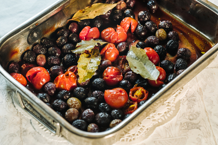 Delicious cooked black olives with cherry tomatoesの写真素材