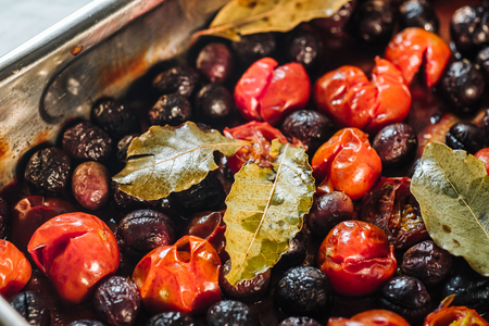 Delicious cooked black olives with cherry tomatoesの写真素材