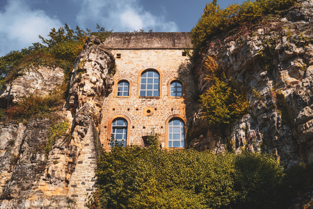 Old architecture between natural rocks in Luxembourg city old townの写真素材
