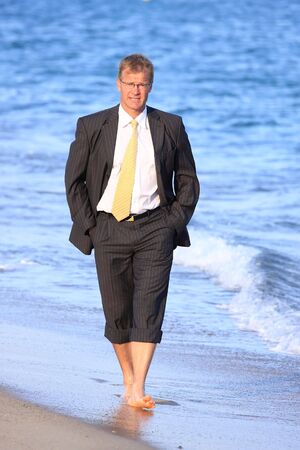 Happy young man walks close to the seaの写真素材