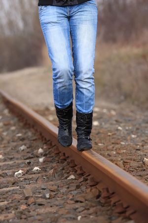 Balancing a thin rails is a difficult taskの写真素材