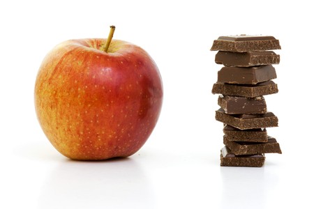 The choice is difficult between the chocolate and the apple の写真素材