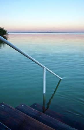 A beautiful sunset on a calm lakeの写真素材