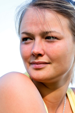 Happy young girl poses in front of the cameraの写真素材