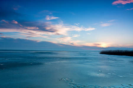 Beautiful winter sunset on the iceの写真素材