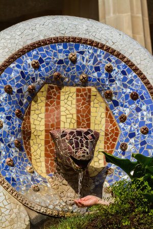 Detail of colorful mosaic work of Park Guell. In 1984 UNESCO declared the park a World Heritage Site...