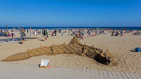 Sand-built dragon on the beach in Barcelona, of Spainのeditorial素材