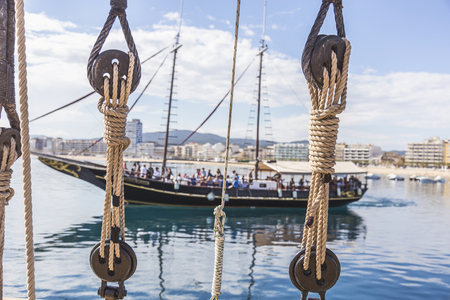 Ship rope and a beautiful sailing boat in the background