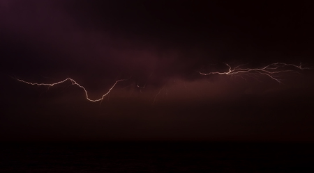 Lightning on the sky over the oceanの写真素材