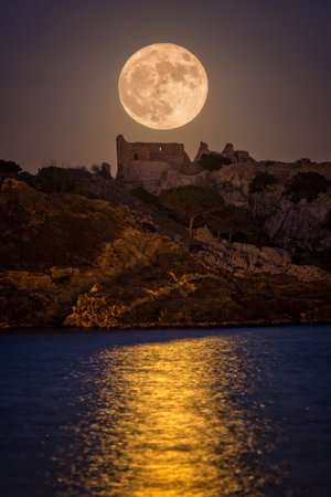 Full moon over the old castle in Costa Brava in a holiday village Fosca , Spainのeditorial素材
