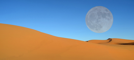 Beautiful sand dunes and blue sky and full moonの写真素材