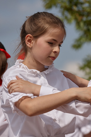 Young girl dancing in a festival in traditional Hungarian costumeの写真素材