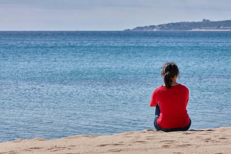 Spanish women setting on the beach at springの写真素材