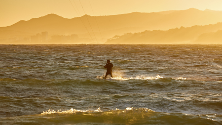 Kite surfer in a sunset light in a Spanish Costa Brava , near the town Palamosの写真素材