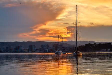 Beautiful sunset light over the mediterranean ocean in Spanish Costa Brava , town Palamosの写真素材