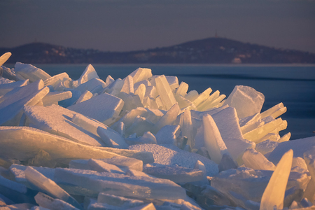 Ice blocks on the lake Balaton from Hungary in sunset lightの写真素材