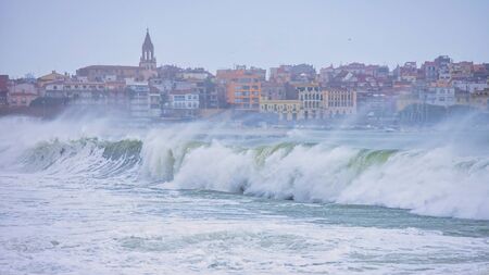 Big waves on the ocean in a cloudy cold winter day.の写真素材