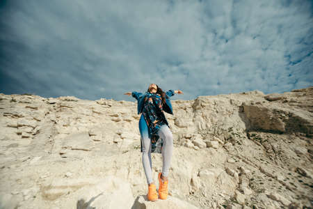 Young woman dressed colorful clothes posing and dancingの写真素材