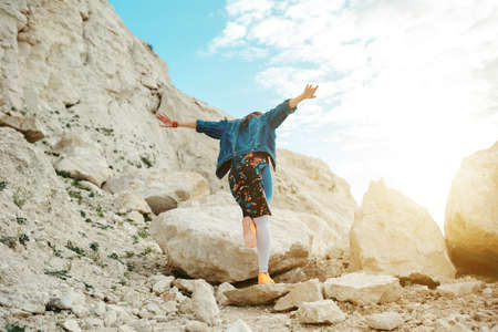 Young woman dressed colorful clothes posing and dancingの写真素材