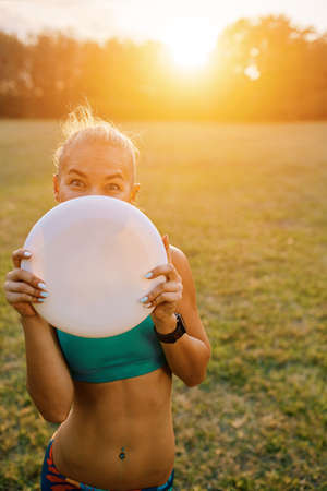 Young athletic girl playing with flying disc, ultimateの写真素材
