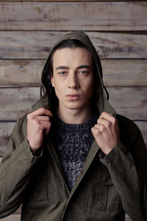 Handsome man in wooden rural house interiorの写真素材