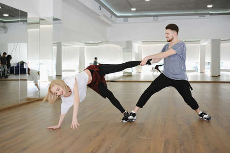 Young modern dancers dancing in the studio. Sport, dancing and urban culture conceptの写真素材
