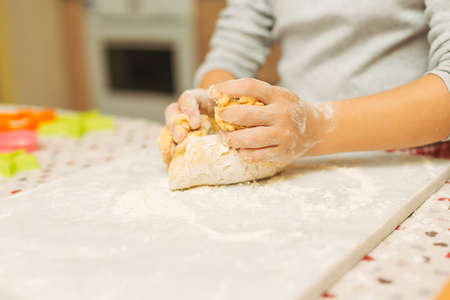Child hands close-up. Holding dough in hands.の写真素材
