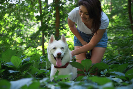 Beautiful modern girl walking with her cute dog.