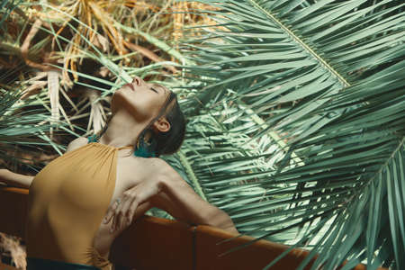 Woman's body beauty and elasticity. Female dancer repeating her performance with closed eyes, while...