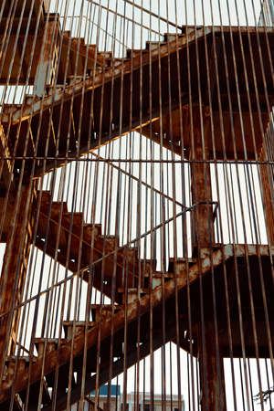 Old stairs and rusty railing heading to sky.の写真素材