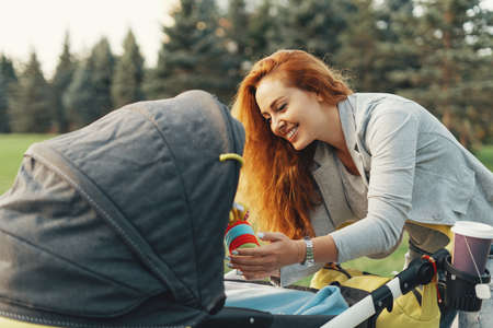 Happy young mother playing and having fun with her little baby