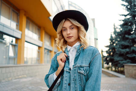 Surprised woman portrait looking to camera while walking on the streetの写真素材