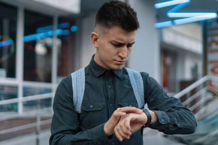 Portrait young man thinking of future on blurred city backgroundの写真素材