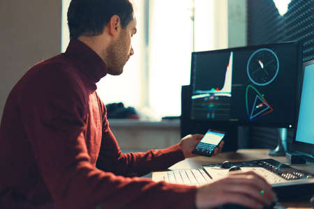 Confident Man Video Editor Works with Footage in Creative Office Studio.