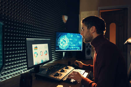 Confident Man Video Editor Works with Footage in Creative Office Studio.