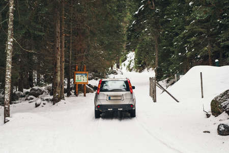 Back view of car on a snowy mountain road