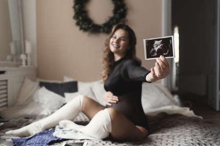 Pregnancy, motherhood, people and medicine concept - smiling, happy pregnant woman showing...