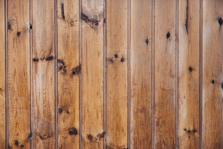 Weathered vertical barn wood background with knots and nail holes