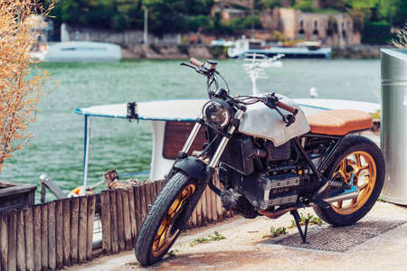 Lyon, France - May 10, 2019. Old motorcycle parked on the banks of the river Saone in Lyon, France