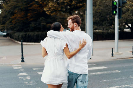 Couple in love walking in the city. Happy to be together. Beautiful young couple holding hands and...