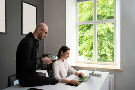 We already have great results. Young beautiful woman smile and discussig something with her coworker...