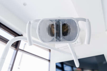 Close-up dentist lamp. Dental work in clinic. Operation, tooth replacement. Medicine, health, stomatology concept.の写真素材