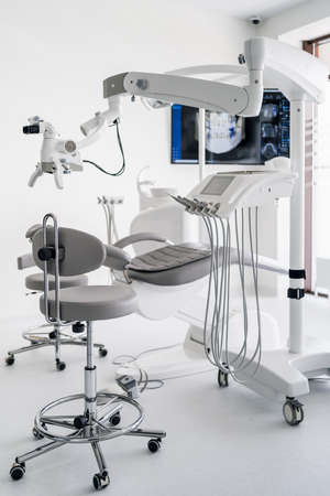 Interior of dental practice room with close up on microscope and dental scan on the display. Stomatology modern equipmentの写真素材